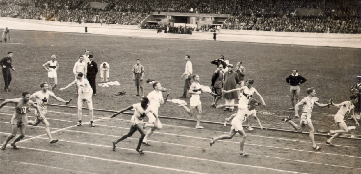People pass batons during a race in the Olympic Stadium